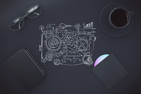 Painted scheme on black table with cup of coffee, diary and CD diskの写真素材