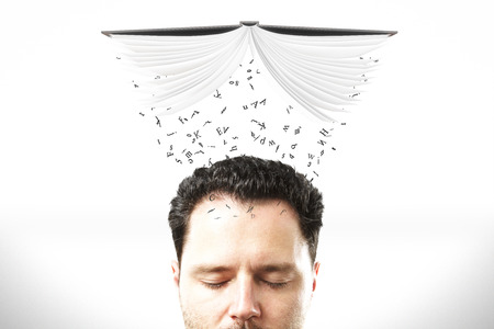 Studying concept with man head with opened book and flying letters above