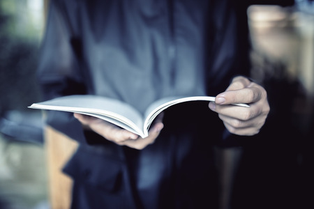 Girl in black coat with notepadの写真素材