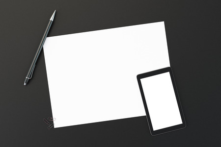 Blank paper with blank smartphone screen and pen on black table, mock upの写真素材