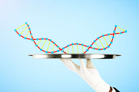 Hand in white glove holding tray with DNA on blue background