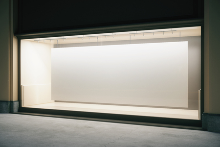 Side view of shop exterior with large banner in empty showcase at night. Mock up, 3D Renderingの写真素材