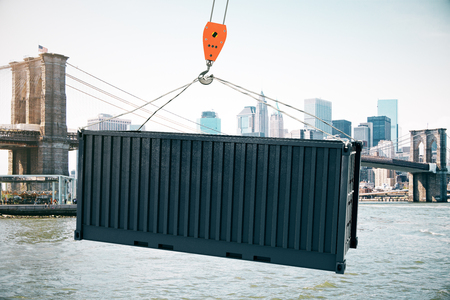 Crane hook with black cargo on city background. 3D Renderingの写真素材