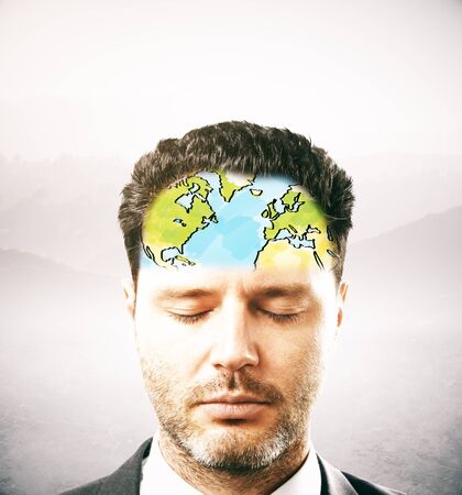 Portrait of thoughtful businessman with map on forehead. Light background