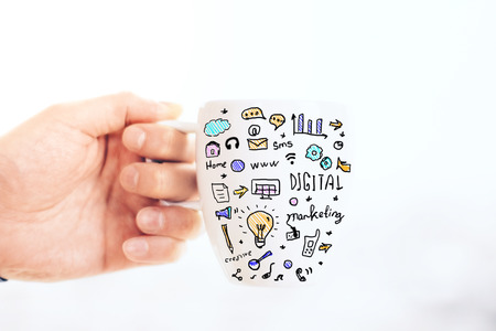 Male hand holding mug with business drawing on light background. Close up, Success conceptの写真素材