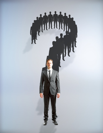 Question mark made of businessmen silhouettes on grey backgroundの写真素材