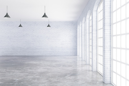 Empty white brick and concrete interior with ceiling lamps and window with no view. 3D Renderingの写真素材