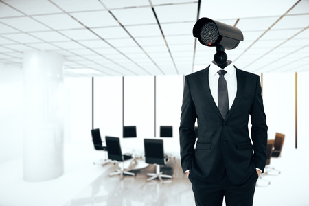 Business security management concept. Businessman with CCTV camera instead of head on conference room backgroundの写真素材