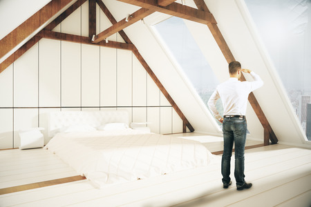 Young man looking into the distnace in loft bedroom interior. Research concept. 3D Renderingの写真素材