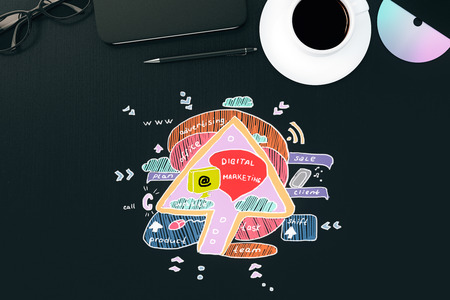 Top view of dark desktop with creative colorful business sketch, coffee cup, notepad and other...