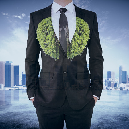 Abstract image of businessman in suit with abstract tree lungs on city background. Environment conceptの写真素材