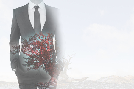 Businessman in suit on abstract background with red tree and copy space. Double exposureの写真素材
