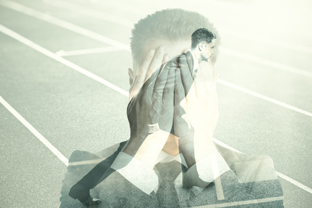 Businessmen covering face and getting ready to run on abstract running track background. Fear of failure concept. Double exposureの写真素材