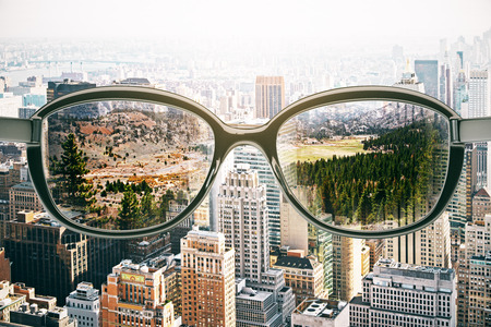 Close up of abstract glasses with landscape view on city background. Vision concept. 3D Rendering