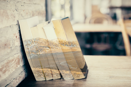 Abstract trabsparent book pile with landscape view. Imagination concept. Double exposureの写真素材