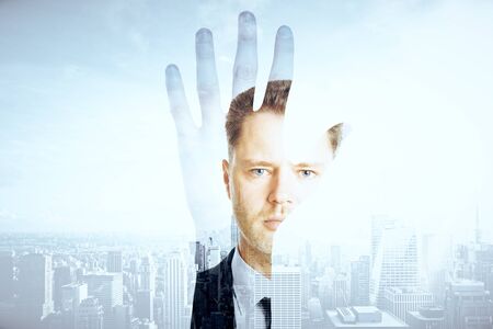 Hand silhouette and businessman on city background. Double exposureの写真素材