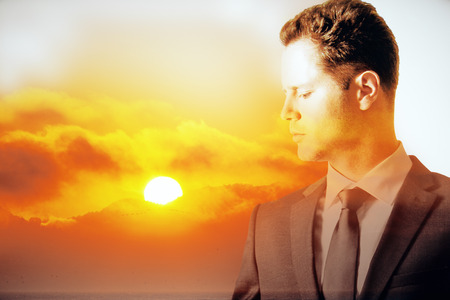 Thoughtful young man on sunset background. Double exposureの写真素材