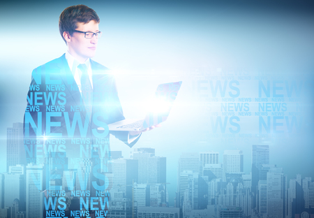 Handsome european businessman using laptop on abstract city news background. Double exposure. Technology conceptの写真素材