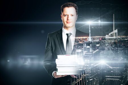 businessman with book on city background. Double exposure. Research conceptの写真素材