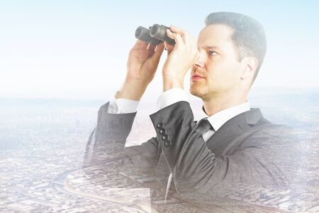 young businessman with binoculars on city background. Double exposure. Research conceptの写真素材