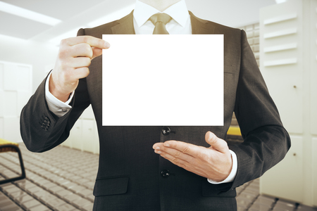 Businessman holding blank card in modern gym interior. Mock up, 3D Renderingの写真素材
