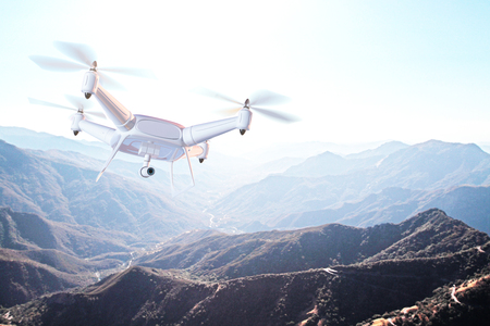 Hovering drone with camera in the sky above mountains.Monitoring concept. 3D Renderingの写真素材
