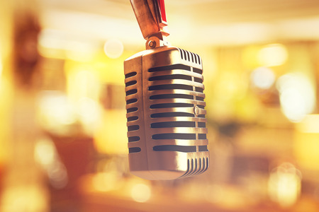 Close up of upside down mic head on bokeh background. Creative speech concept. 3D Rendeirngの写真素材