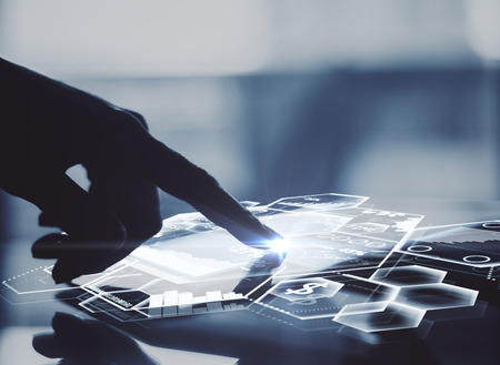 Side view of male hand using tablet with abstract digital charts and honeycomb cells. Modern business technologies concept. 3D Renderingの写真素材