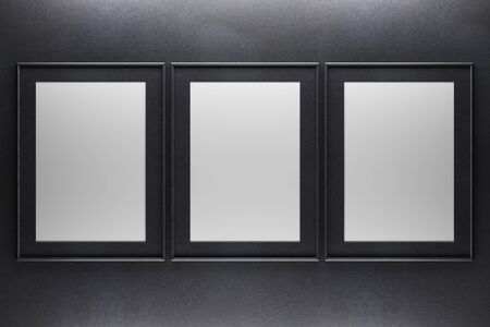 Three blank picture frames on dark concrete background. Mock up, 3D Renderingの写真素材