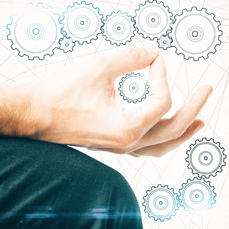 Creative image of male hand drawing abstract drawn cogwheels. Teamwork conceptの写真素材