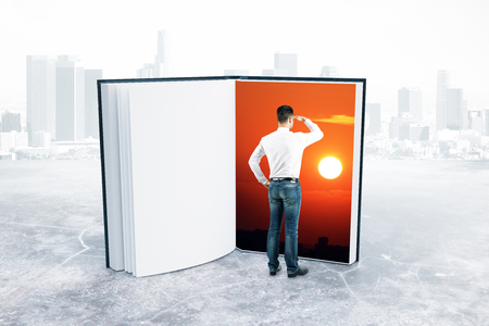 Abstract image of businessman looking into book with sunset on page. Imagination concept. 3D Renderingの写真素材