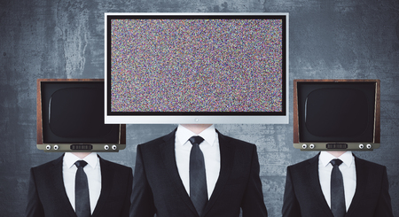 Obsolete and modern TV headed businessmen on concrete background. Mock upの写真素材
