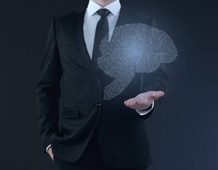 Businessman holding abstract digital human brain hologram on blue background. Future concept