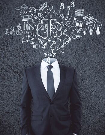 Headless businessman standing on concrete background with business sketch. Solution conceptの写真素材