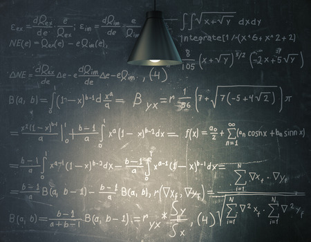 Blackboard with mathematical formulas illuminated with lamp. Education conceptの写真素材