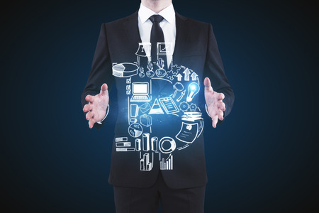 Unrecognizble businessman holding abstract bitcoin business chart on dark background. Leadership and e-commerce conceptの写真素材