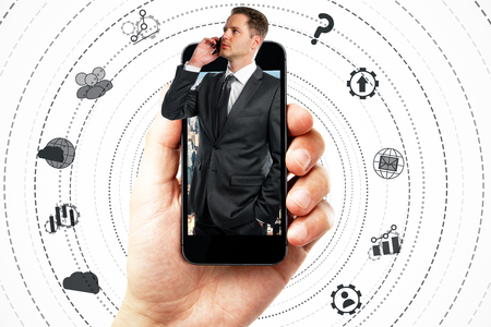 Abstract image of hand holding smartphone with businessman and digital business network on white background. Innovation conceptの写真素材