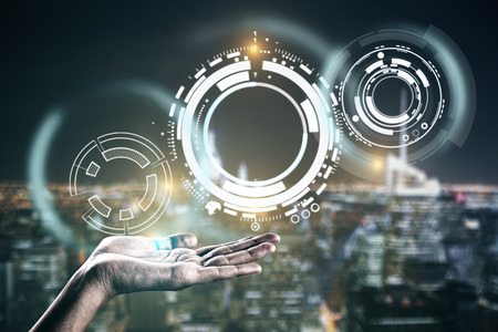Hand holding abstract digital interface on night city background. Communication concept. Double...
