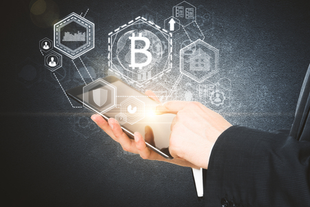 Businessman hands using tablet with abstract glowing bitcoin projection. Cryptocurrency concept. 3D Renderingの写真素材