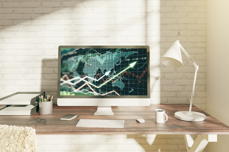 Creative office desktop with forex chart on computer screen, coffee cup and other items. Brick wall background. Investment concept. 3D Renderingの写真素材