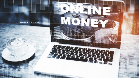 Close up of workplace with laptop, coffee cup, forex chart and other items. Toned image. Online money and trade concept. Double exposure の写真素材