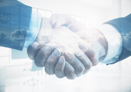 Close up and side view of handshake on abstract office and cloudscape background. Teamwork and finance concept. Double exposure の写真素材