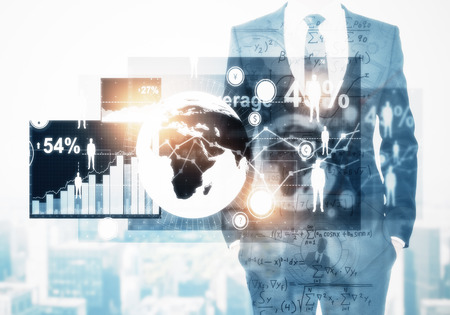 Unrecognizable businessman with glowing business interface on abstract city background. Innovation and media concept. Double exposure の写真素材