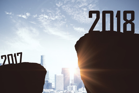 Mountain gap between 2017 and 2018 on city backdrop. New Year concept 