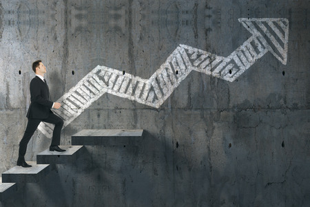 Side view of young businessman climbing stairs on abstract concrete background with drawn arrow. Career and success concept. 3D Rendering の写真素材