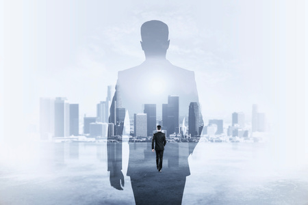 Back view of young businessman walking on abstract city background. Success and employment concept....