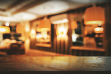 Empty wooden counter on blurry bar interior backgroud. Montage concept の写真素材