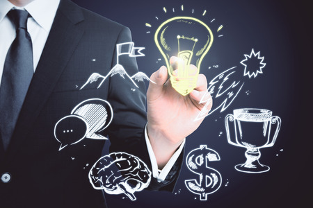 Businessman hand drawing creative business sketch on dark background. Finance and plan concept の写真素材