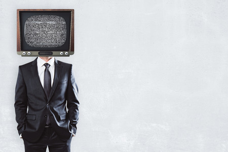 TV headed businessman standing on concrete background with copy spaceの写真素材