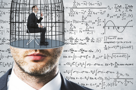 Cage headed businessman on concrete wall background with mathematical formulas. Freedom and science concept の写真素材